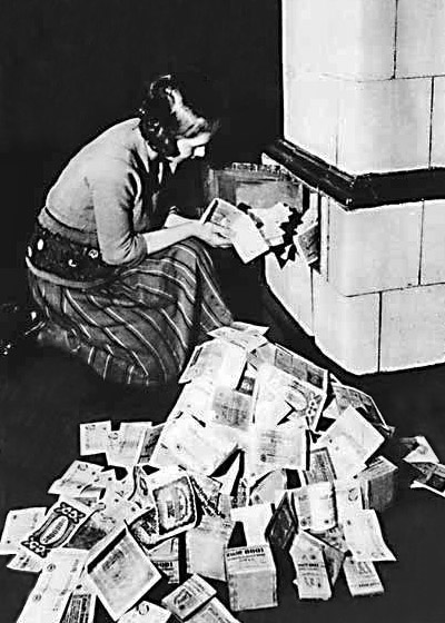 German woman burning money to stay warm