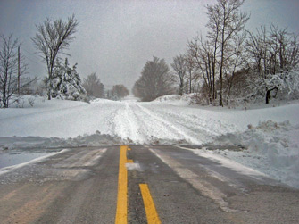 road cleared of snow versus not plowed
